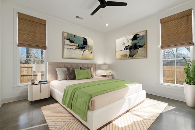 bedroom featuring ceiling fan, multiple windows, and ornamental molding