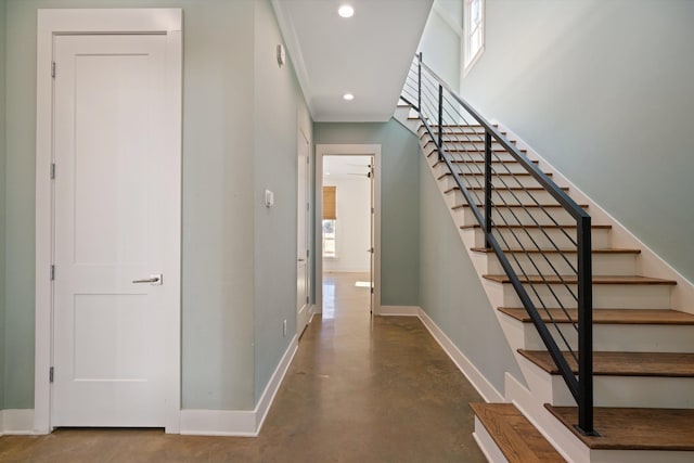 interior space featuring ceiling fan and concrete flooring