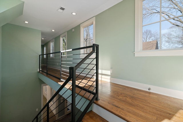 stairs with hardwood / wood-style floors