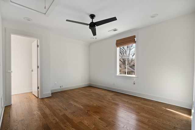 unfurnished room with ceiling fan and dark wood-type flooring