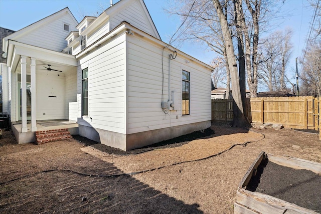 view of side of property featuring ceiling fan and central AC