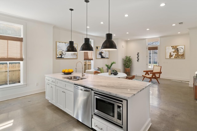 kitchen with concrete floors, sink, white cabinetry, light stone countertops, and appliances with stainless steel finishes