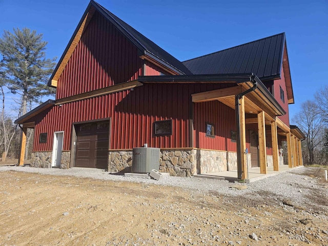 view of side of home featuring a garage and central AC unit