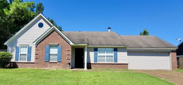 ranch-style house featuring a front yard and a garage