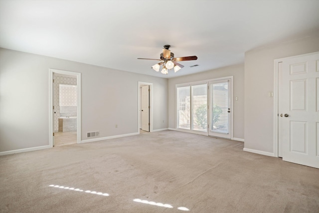 spare room featuring ceiling fan and light carpet