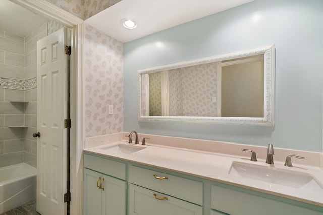 bathroom with vanity and tiled shower / bath combo