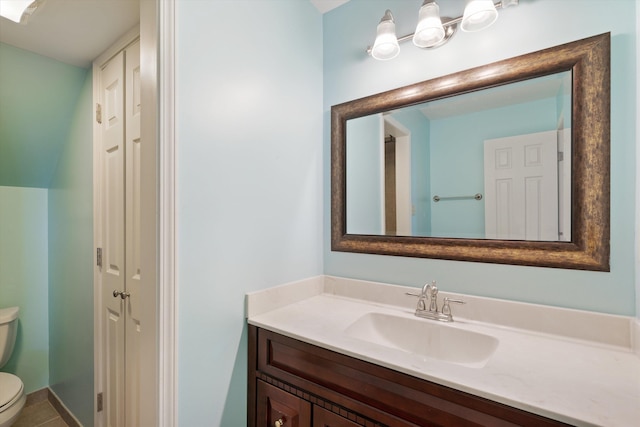 bathroom featuring toilet, tile patterned flooring, and vanity