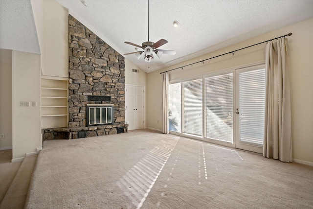 unfurnished living room with light carpet, ceiling fan, lofted ceiling, and a stone fireplace