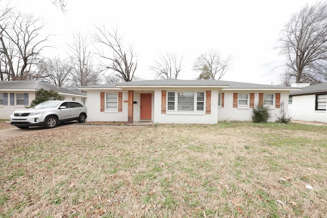 ranch-style home with a front lawn