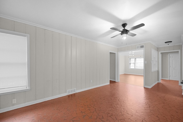 unfurnished room featuring ceiling fan with notable chandelier and ornamental molding