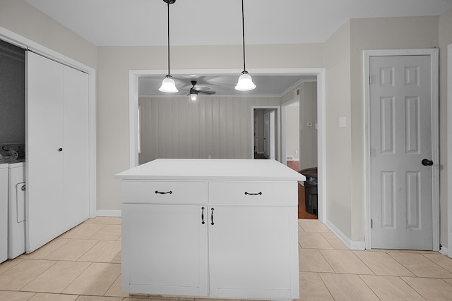 kitchen with light tile patterned floors, pendant lighting, white cabinets, and a center island