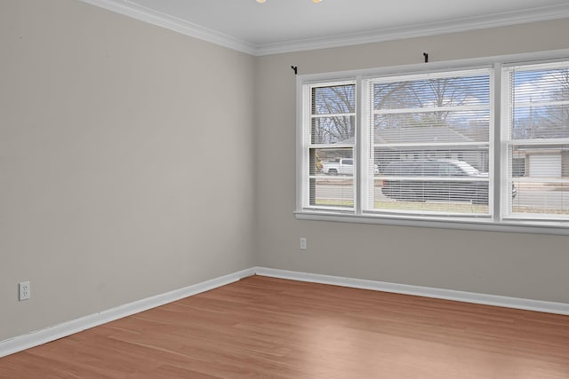 empty room featuring crown molding and light hardwood / wood-style flooring