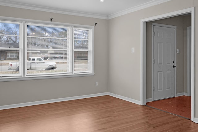 unfurnished room featuring ornamental molding and hardwood / wood-style flooring