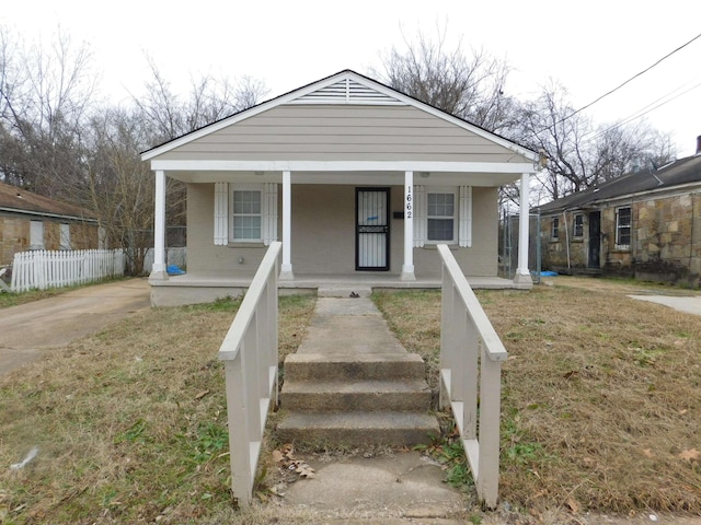 bungalow-style home with a front yard and a porch