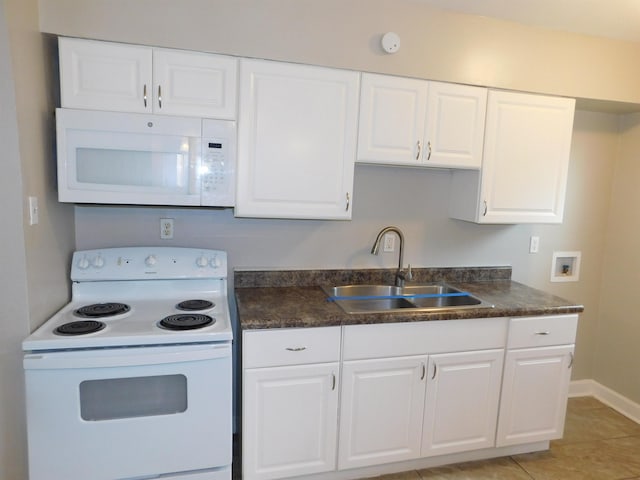 kitchen with white cabinets, sink, white appliances, and light tile patterned flooring