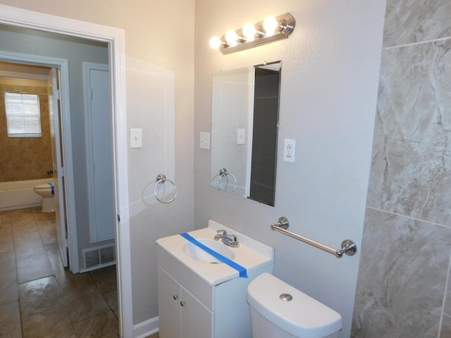 bathroom featuring toilet and vanity