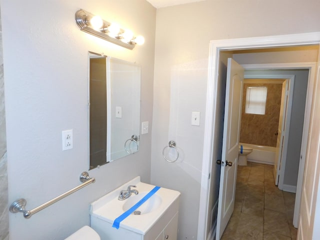 bathroom with tile patterned floors, toilet, vanity, and a bathing tub