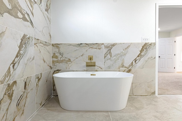 bathroom with a washtub and tile walls