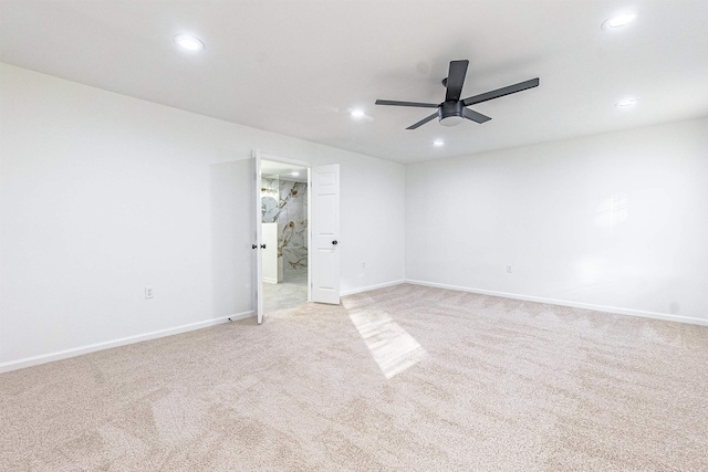 unfurnished room with ceiling fan and light colored carpet