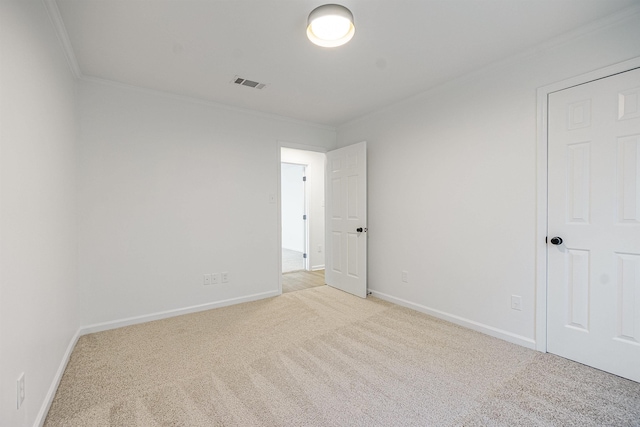 carpeted empty room with crown molding