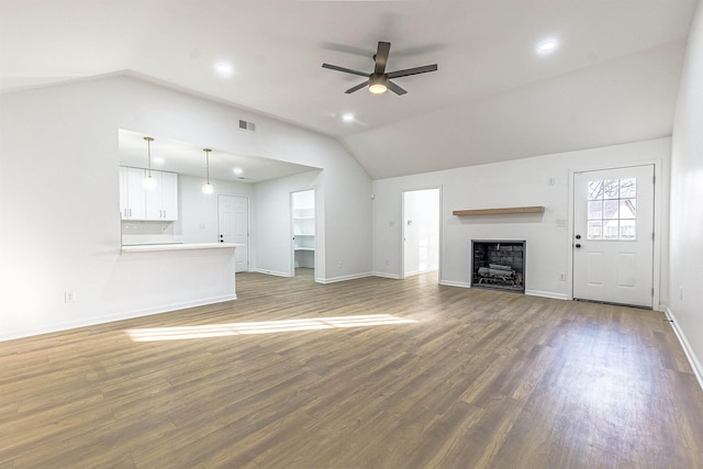 unfurnished living room featuring ceiling fan, wood-type flooring, and lofted ceiling