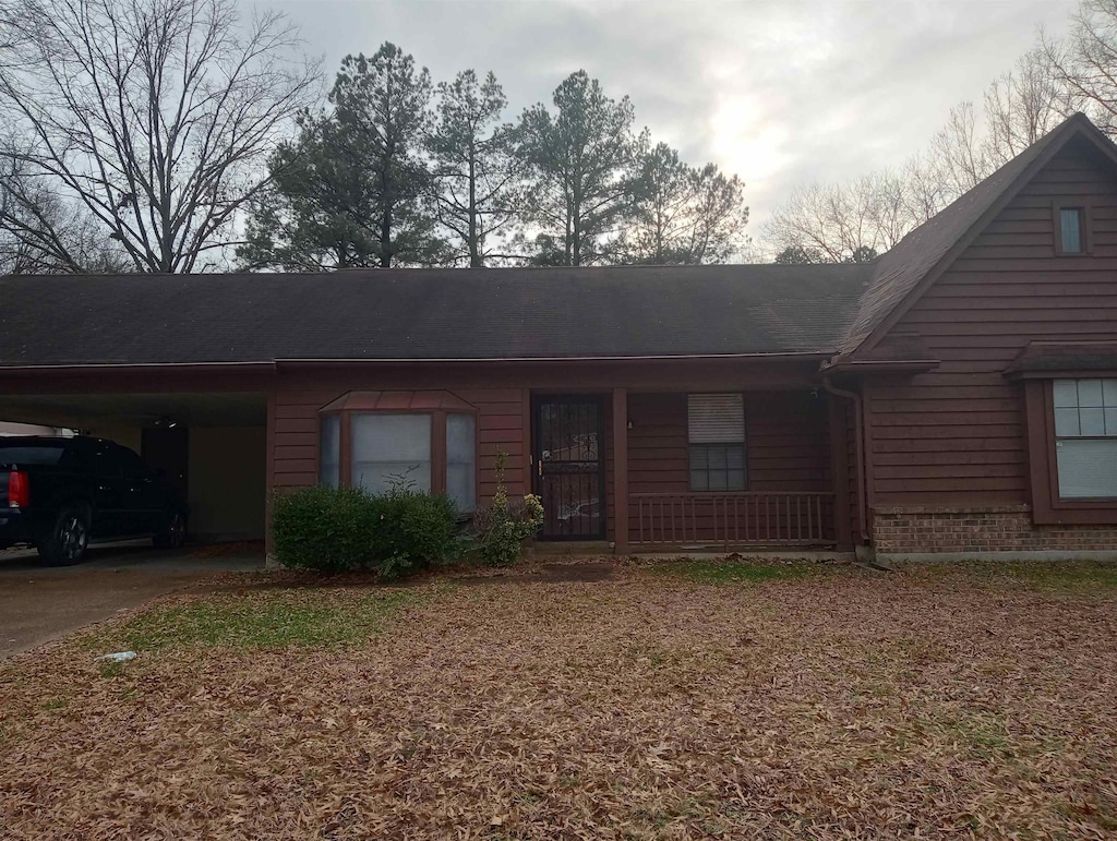 ranch-style home with a carport