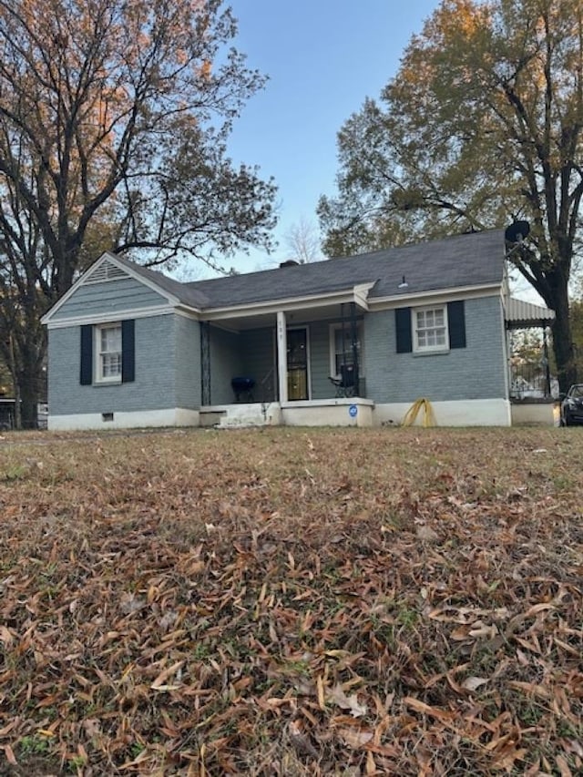 back of property with covered porch