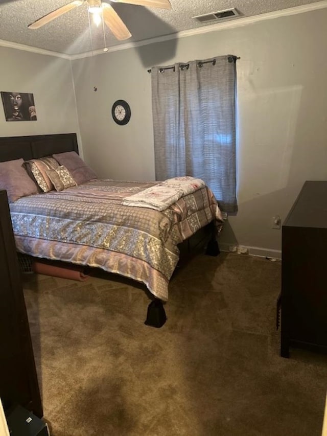 carpeted bedroom with ceiling fan, a textured ceiling, and ornamental molding