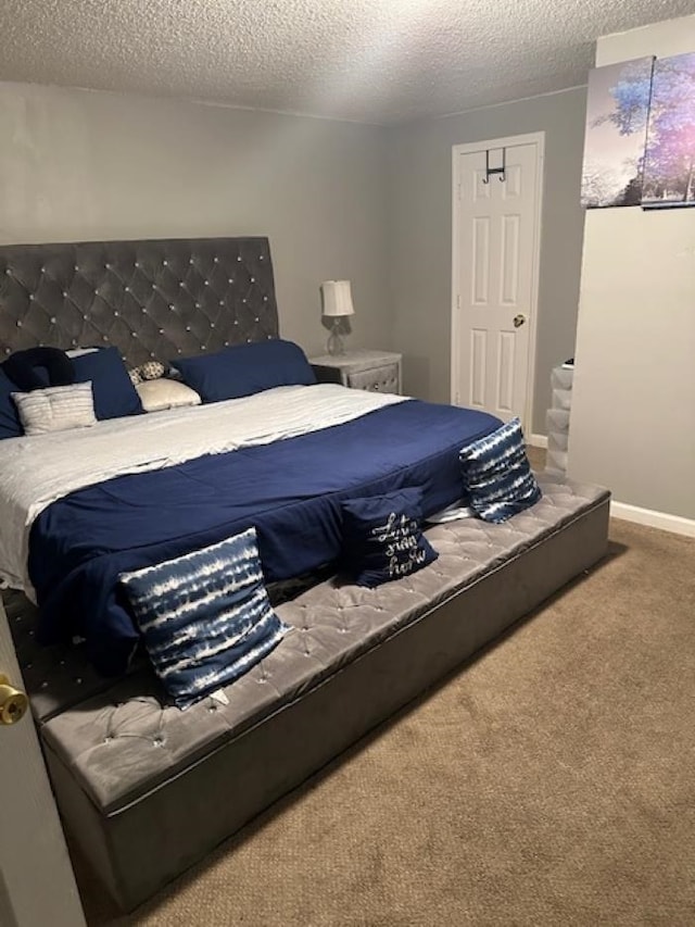 carpeted bedroom featuring a textured ceiling