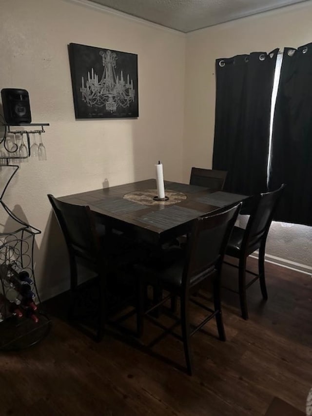 dining room with a textured ceiling and dark hardwood / wood-style floors