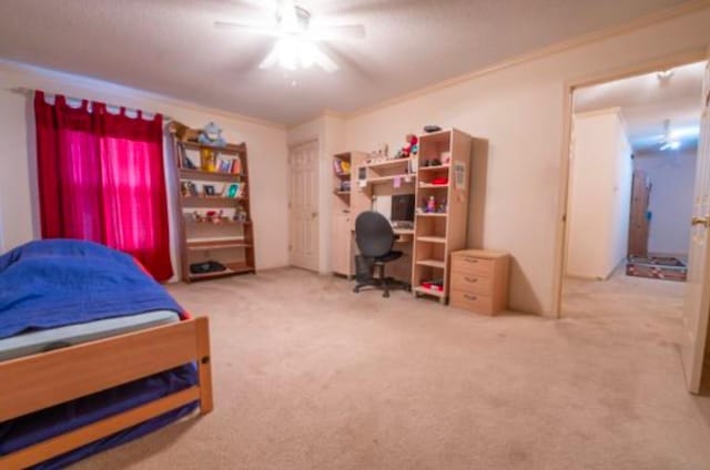 bedroom with ceiling fan, carpet, and crown molding