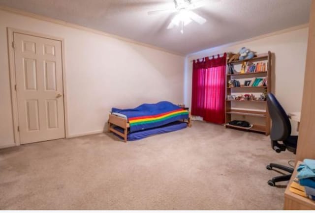 bedroom featuring ceiling fan, carpet, ornamental molding, and a textured ceiling