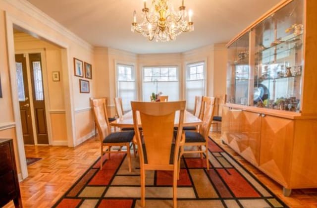 dining space with a chandelier and light parquet flooring