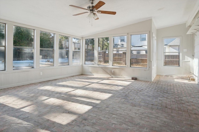 unfurnished sunroom featuring vaulted ceiling, ceiling fan, and plenty of natural light