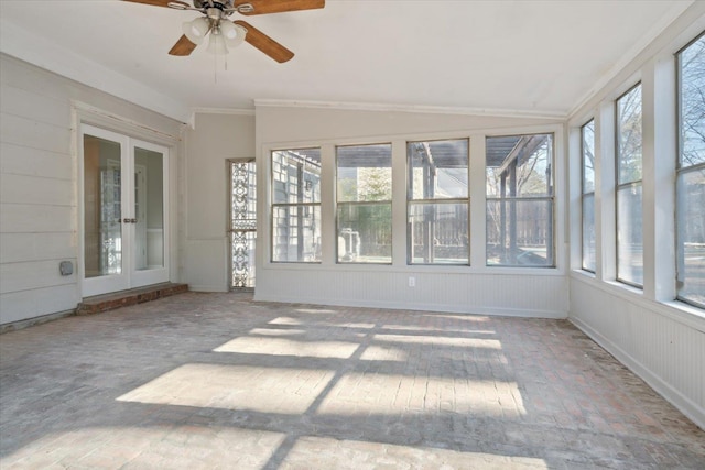 unfurnished sunroom with ceiling fan