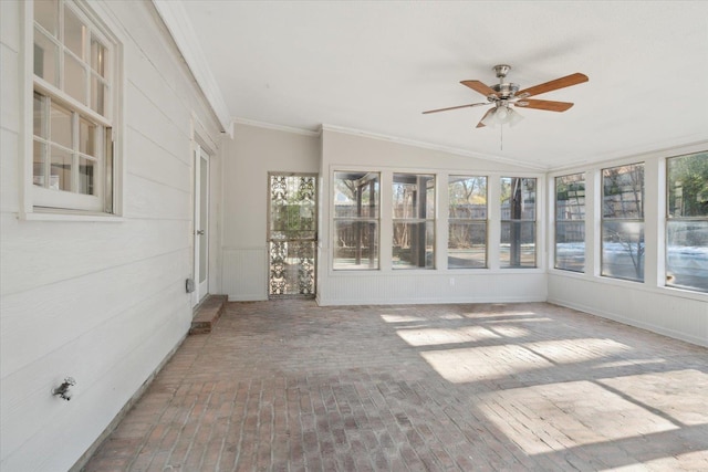 unfurnished sunroom with ceiling fan