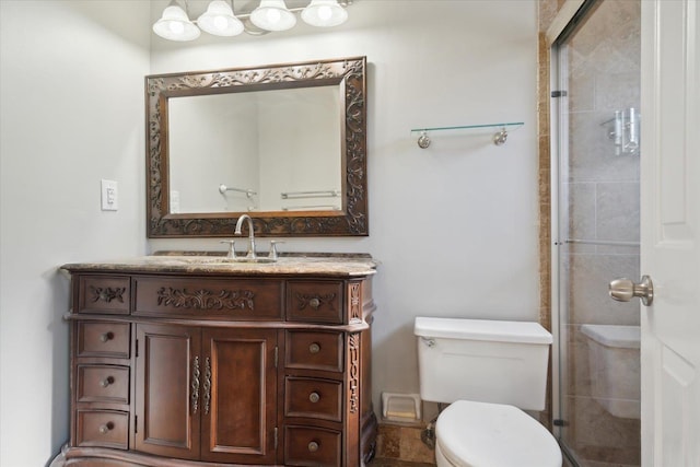 bathroom featuring toilet, tiled shower, and vanity