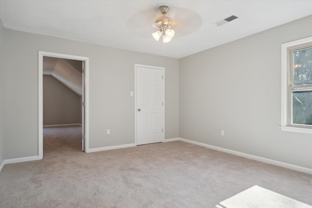 unfurnished bedroom featuring light carpet, baseboards, visible vents, and ceiling fan