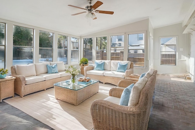 sunroom / solarium with lofted ceiling and ceiling fan