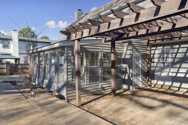 exterior space with a patio area, fence, and a pergola