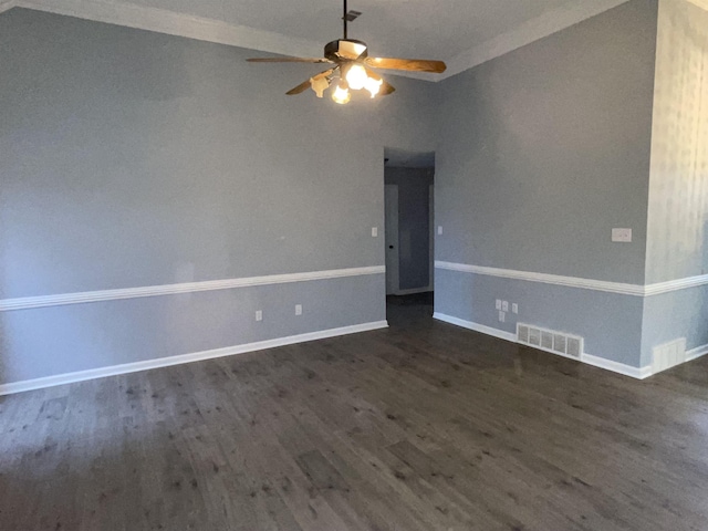 unfurnished room featuring ceiling fan, dark wood-type flooring, and crown molding