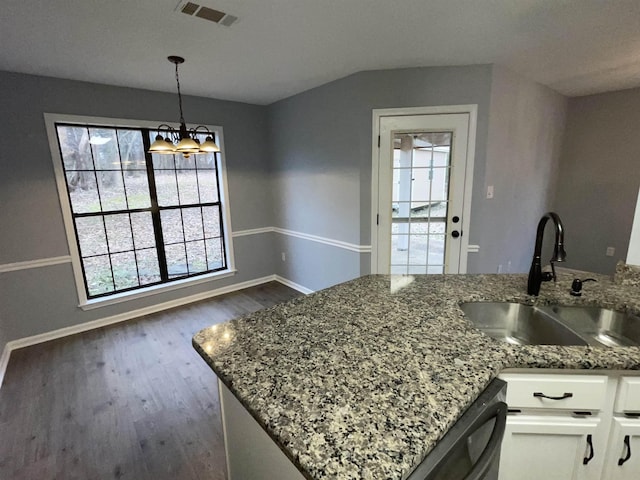 kitchen featuring decorative light fixtures, dishwasher, sink, white cabinets, and stone countertops