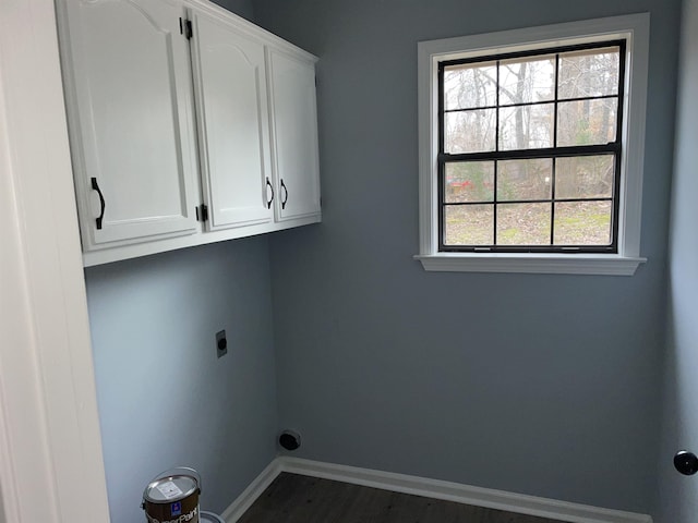 laundry room with a wealth of natural light, hookup for an electric dryer, and cabinets