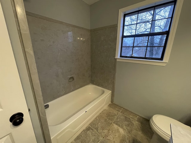 bathroom with toilet and tub / shower combination