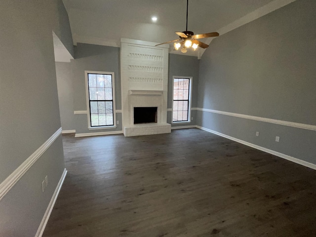 unfurnished living room featuring a brick fireplace, a wealth of natural light, ceiling fan, and high vaulted ceiling