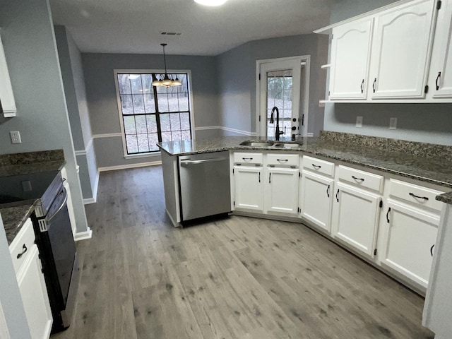 kitchen with pendant lighting, kitchen peninsula, sink, stainless steel appliances, and white cabinets