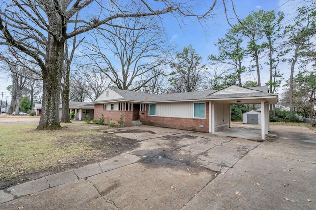 ranch-style home featuring a carport