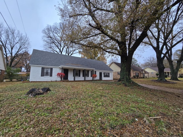 ranch-style home featuring a front yard