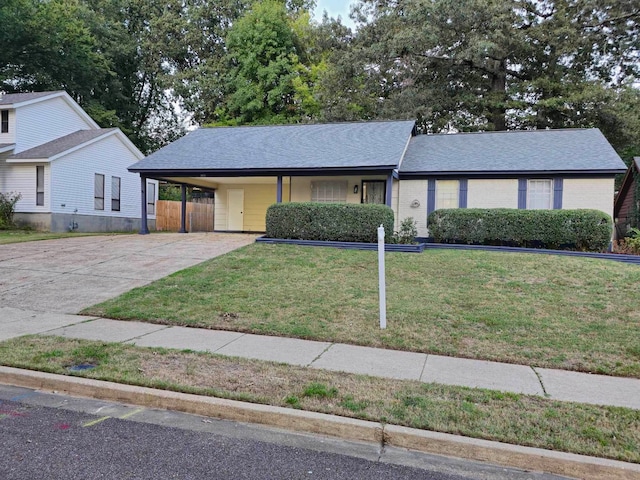 single story home with a front lawn and a carport