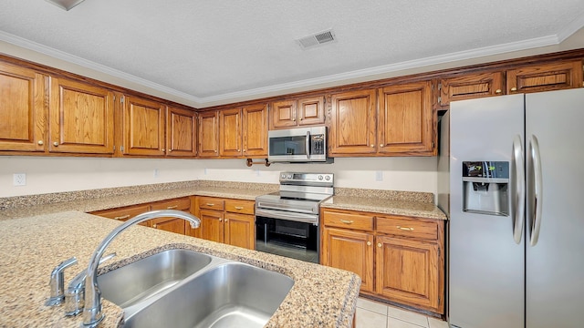 kitchen with appliances with stainless steel finishes, sink, light tile patterned flooring, light stone counters, and crown molding